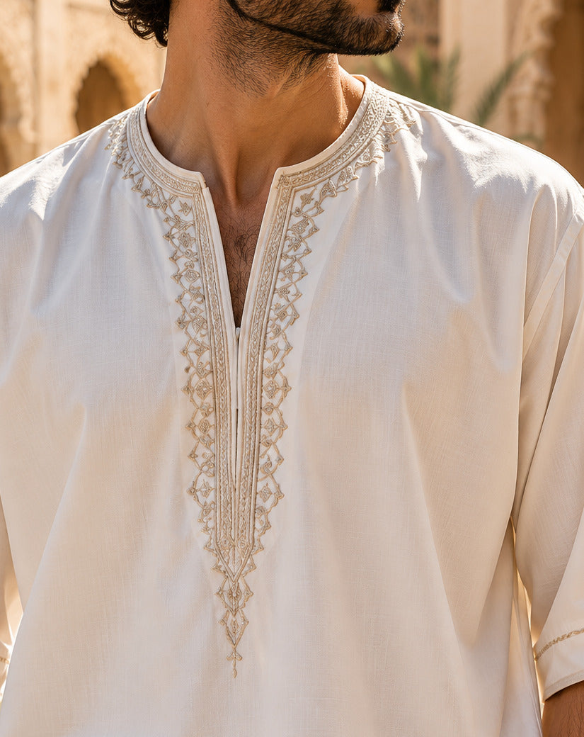 Detailed gold-tone embroidery on an ivory Moroccan gandoura